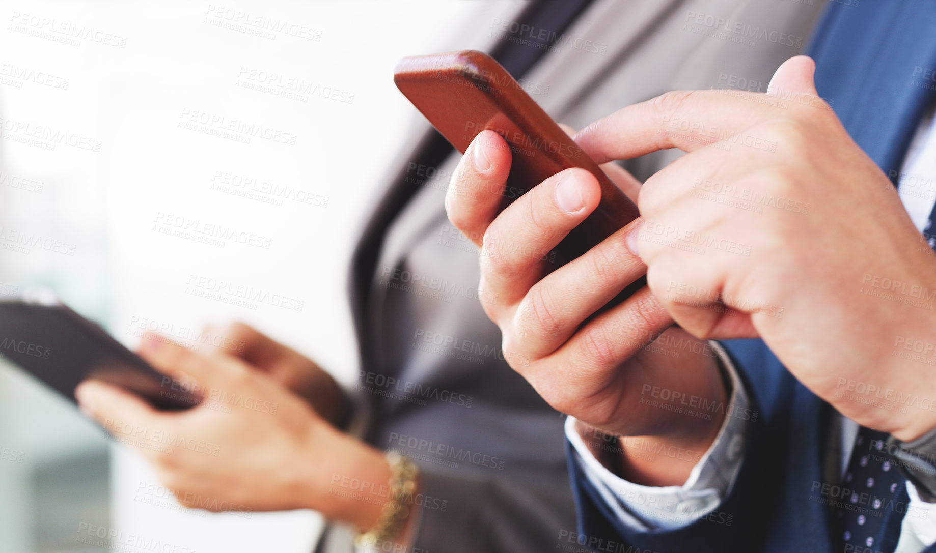 Buy stock photo Cropped shot of a two unrecognizable businesspeople using technology while in the office during the day