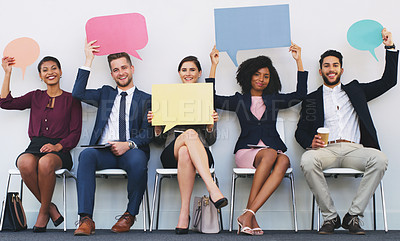 Buy stock photo Full length portrait of a diverse group of businesspeople sitting and holding blank cards while in the office