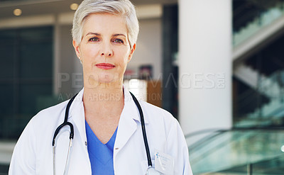 Buy stock photo Cropped portrait of a mature healthcare professional standing in her uniform while indoors during the day