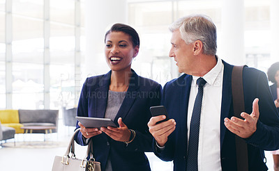 Buy stock photo Business black woman and man talking, walking and in office for planning together. Coworkers, female manager and male employee have conversation, tablet and smartphone for discussion and strategy.