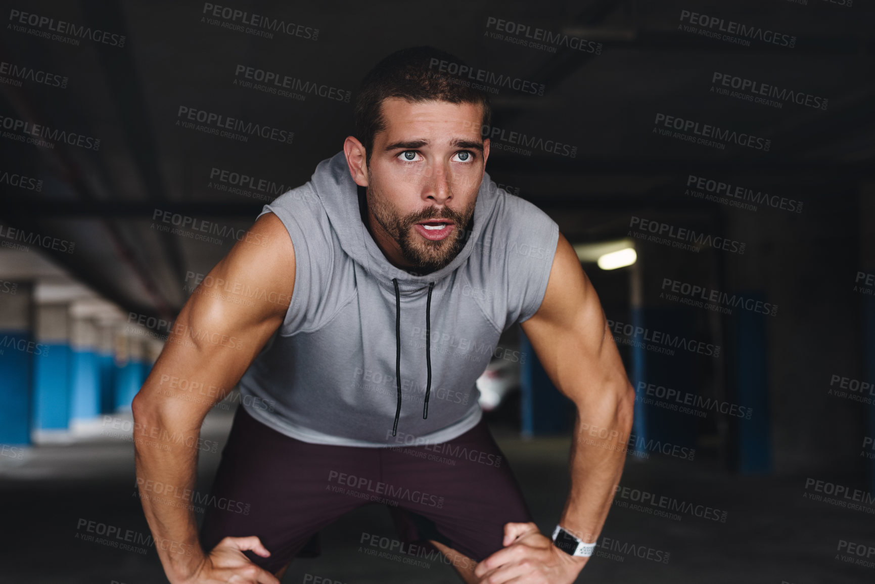 Buy stock photo Tired, breathe and man with break in exercise for sports training, fatigue and workout recovery. Exhausted, athlete and person with rest in parking lot for fitness, challenge and run in morning