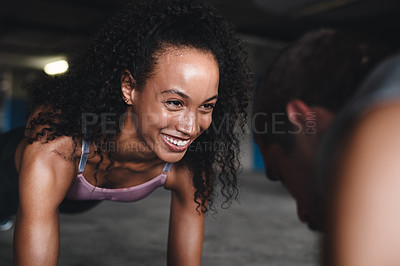 Buy stock photo Shot of a sporty young couple exercising together inside an underground parking lot