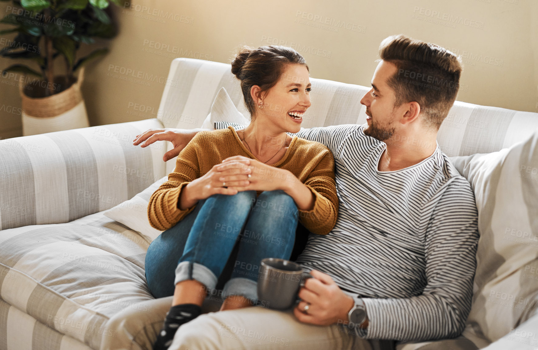 Buy stock photo Cropped shot of a young couple relaxing on the sofa at home