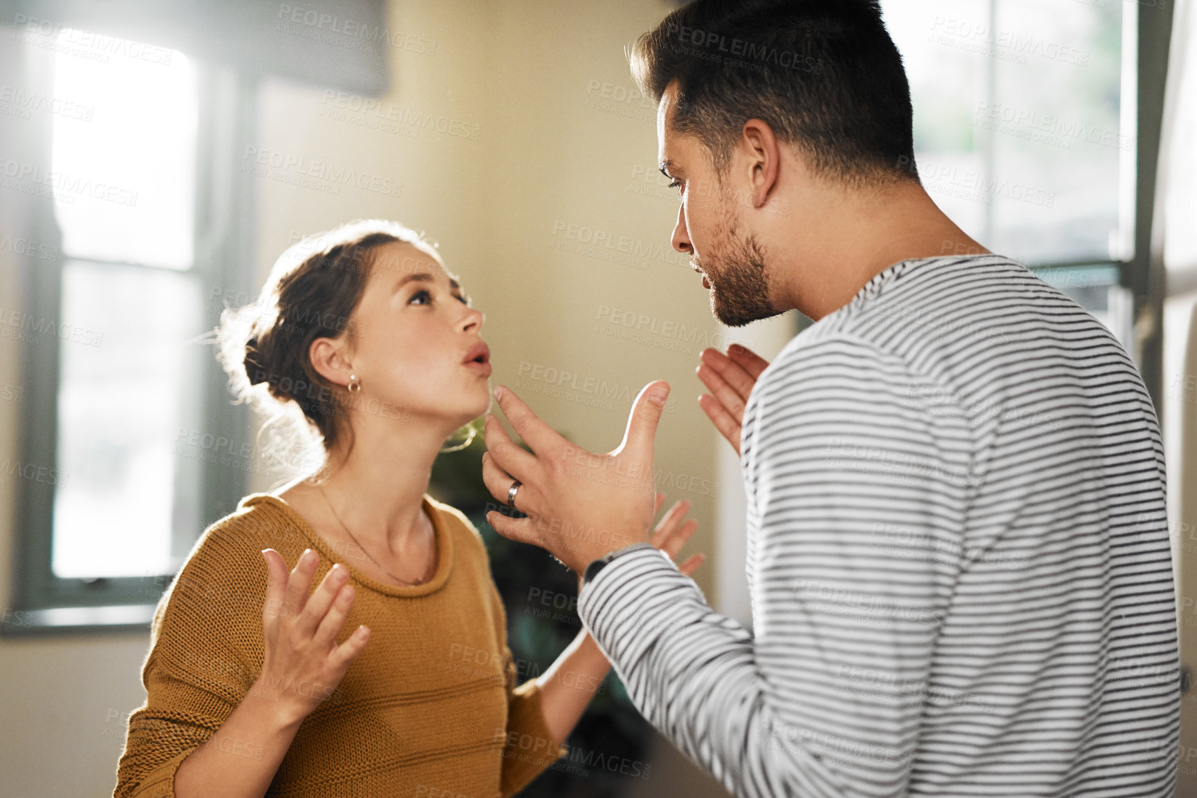 Buy stock photo Cropped shot of a young couple having an argument at home