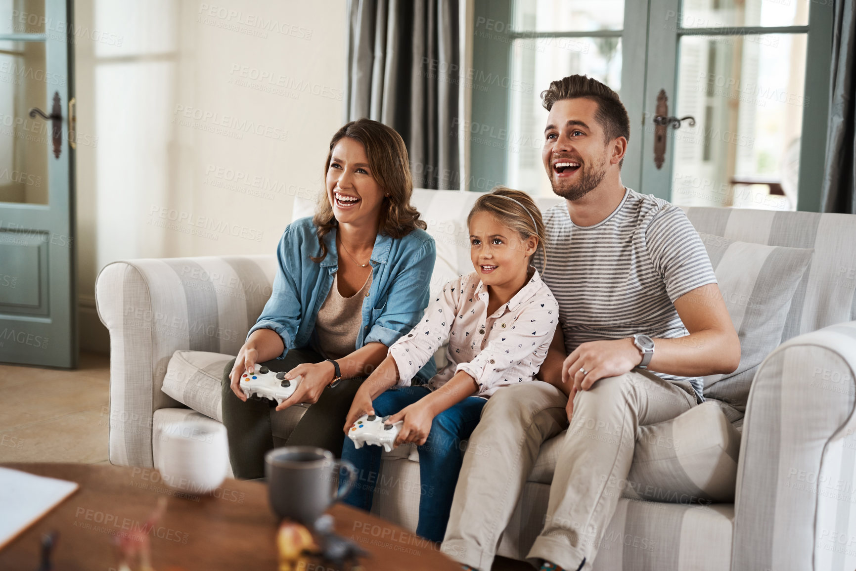 Buy stock photo Parents, girl and video game with controller on couch with laugh, care or smile for competition in lounge. Father, mother and daughter with contest, challenge or learning with strategy in family home