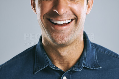 Buy stock photo Closeup shot of an unrecognizable man smiling against a grey background