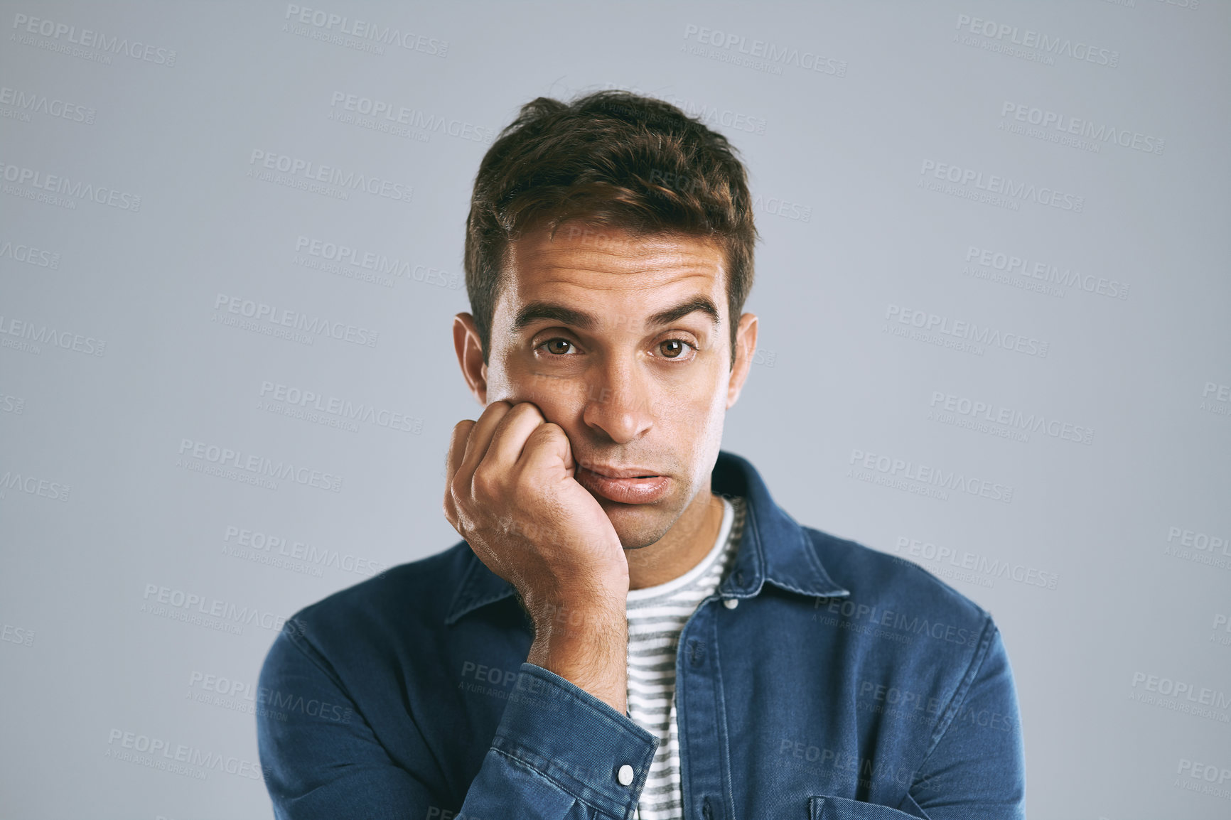 Buy stock photo Cropped shot of a handsome man looking bored against a grey background