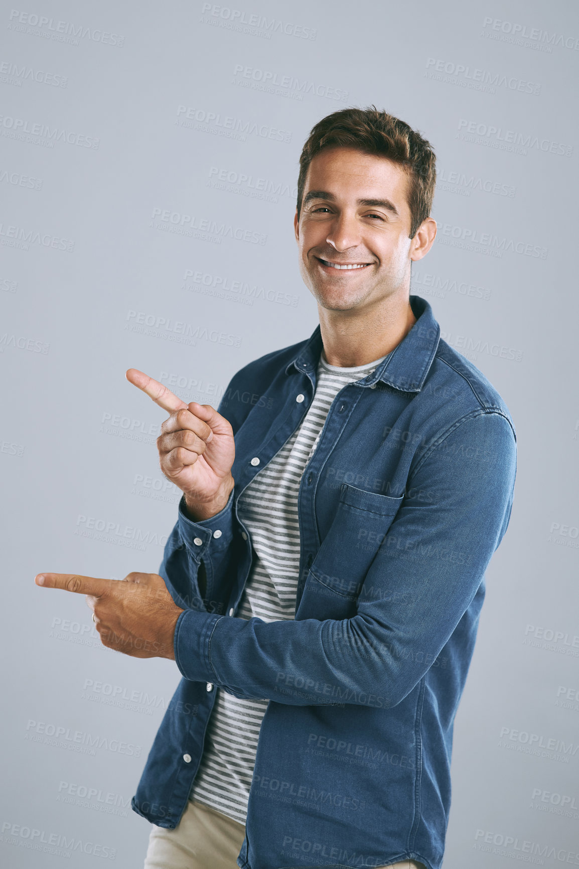 Buy stock photo Portrait, pointing and man with review, menu and information on grey studio background. Face, person and guy with hand gesture, mockup space and promotion with discount deal, opportunity and review