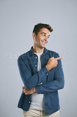 Buy stock photo Portrait, pointing and man with review, promotion and model on grey studio background. Face, person and guy with hand gesture, mockup space or opportunity with discount deal, option or fashion choice