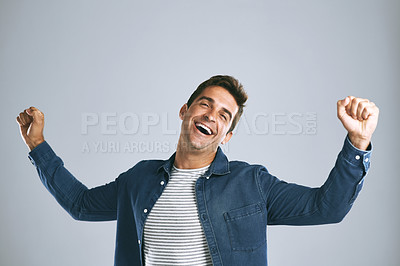 Buy stock photo Cropped shot of a handsome man cheering against a grey background