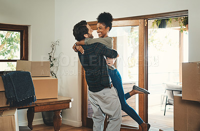 Buy stock photo Homeowner couple celebrating, hugging and cheering in new home as real estate investors, buyers and owners. Fun interracial man and woman looking excited, happy and cheerful while embracing by boxes