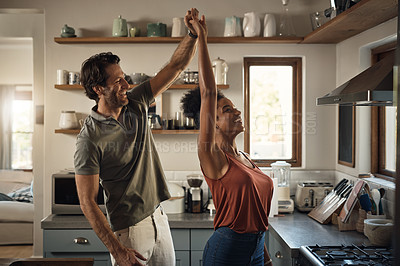 Buy stock photo Interracial couple, happy and dance in kitchen for fun bonding, love or holiday together at home. Man and woman dancing in joyful happiness for relationship, romance or enjoying weekend in the house