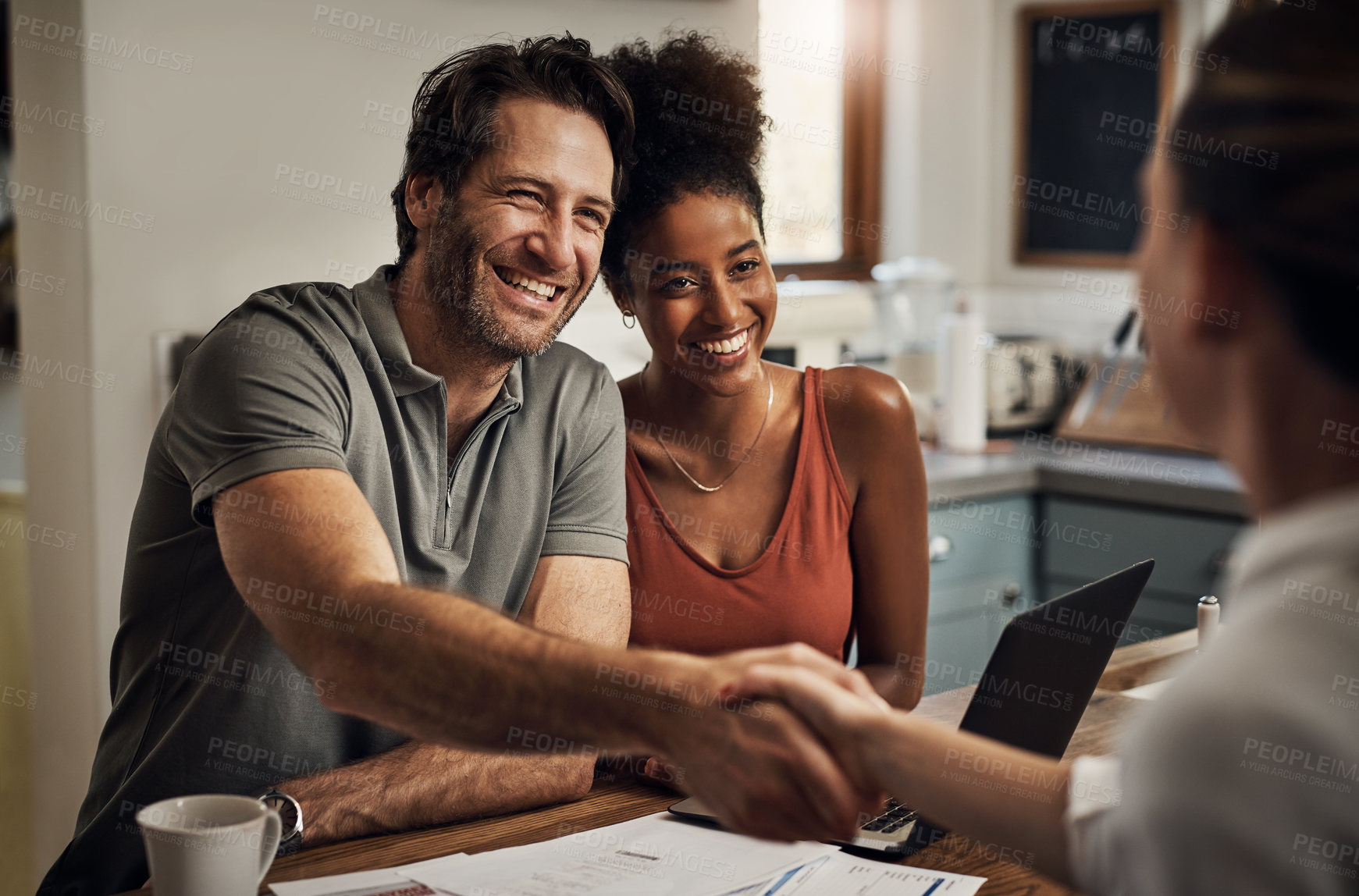 Buy stock photo Cropped shot of a handsome middle aged man shaking hands with a financial advisor during a consultation at home
