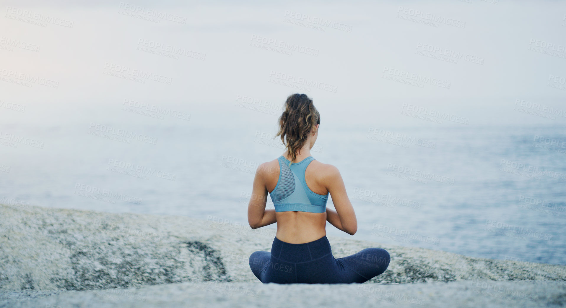 Buy stock photo Prayer, yoga or woman in beach meditation for peace, wellness or mindfulness in outdoor nature. Chakra, calm or back view of girl on rock at sea or ocean for awareness or balance in pilates to relax