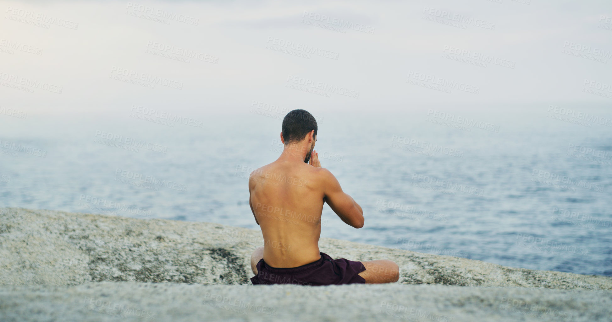 Buy stock photo Calm, yoga or man at sea in meditation for peace, wellness or mindfulness in outdoor nature to relax. Chakra, holistic or back view of yogi on rock at beach for awareness or balance in pilates