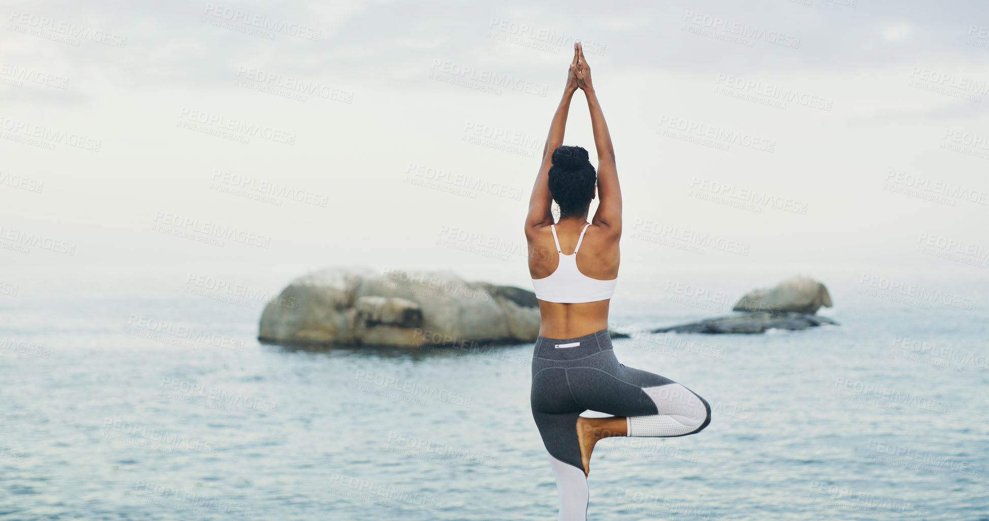 Buy stock photo Beach, yoga or girl with balance or body flexibility for peace or mindfulness in outdoor nature to relax. Chakra, calm or back view of woman on rock at sea or ocean for awareness or soul in pilates