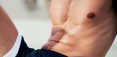 Buy stock photo Closeup shot of an unrecognizable  shirtless young sportsman taking a break after a workout outdoors