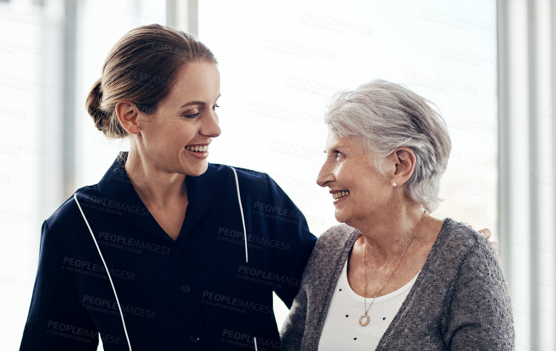 Buy stock photo Cropped shot of a female nurse caring for a senior woman