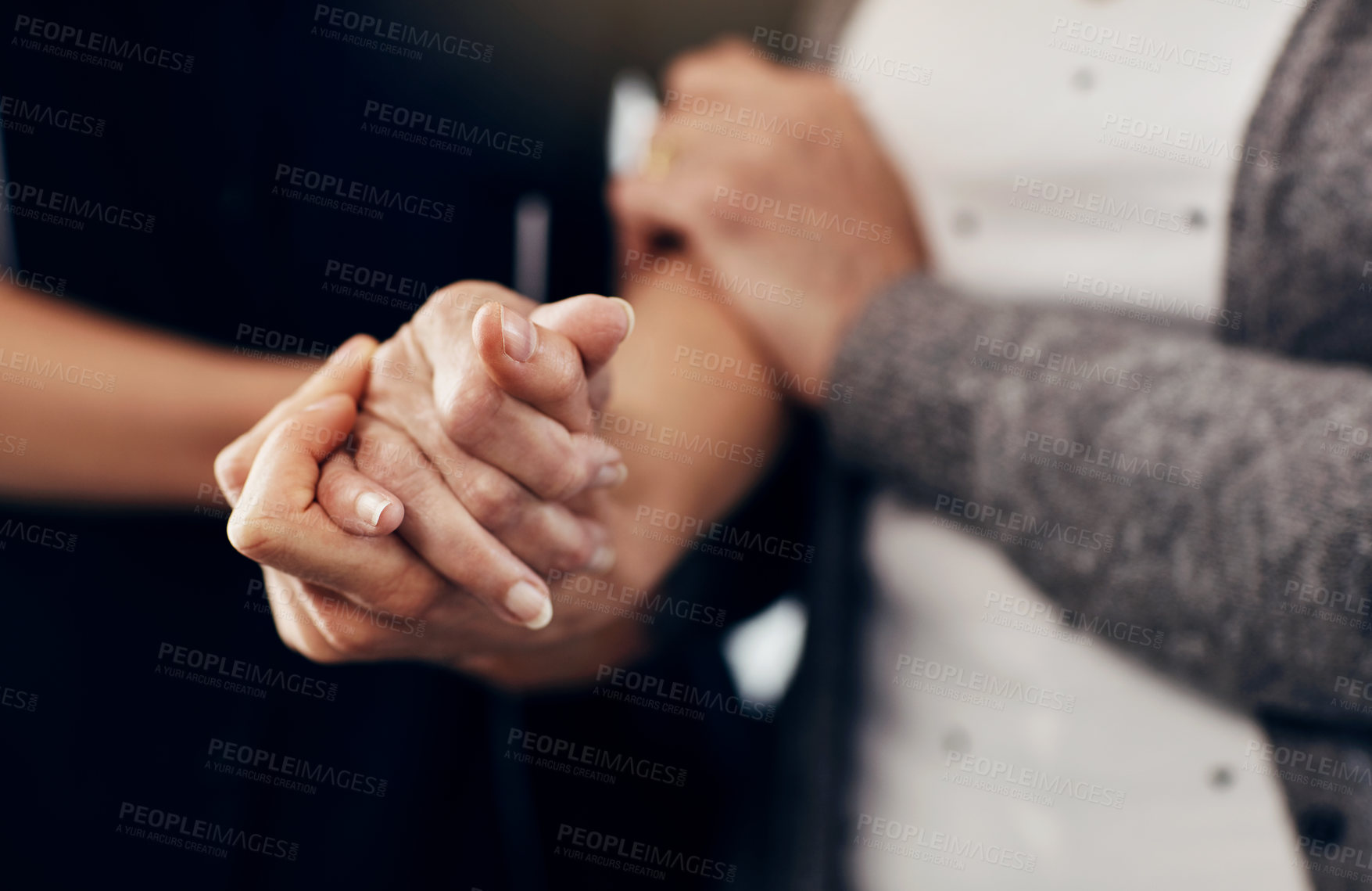 Buy stock photo Cropped shot of a female caregiver holding a senior woman's hands