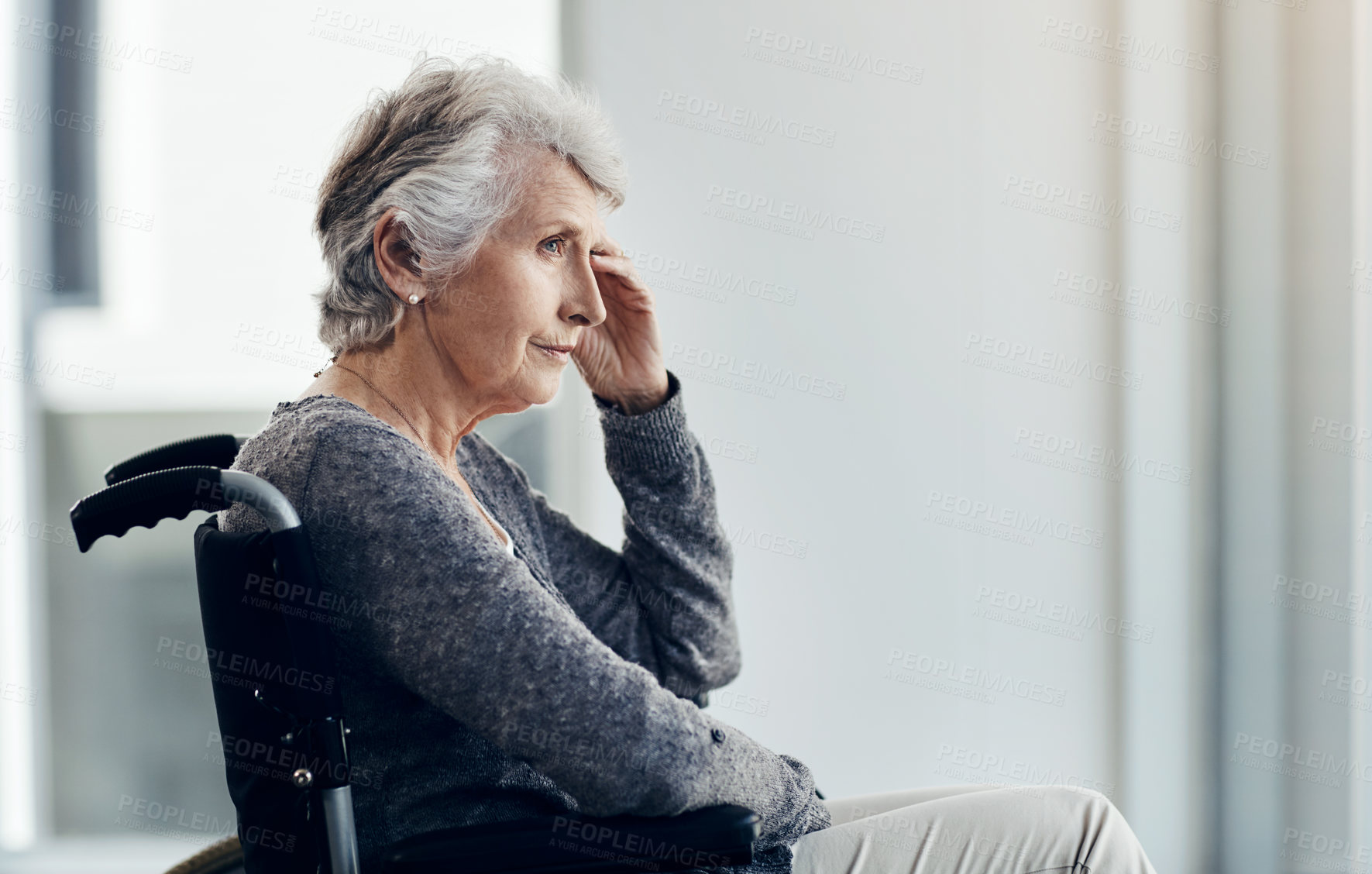 Buy stock photo Cropped shot of a senior woman looking thoughtful while sitting in her wheelchair