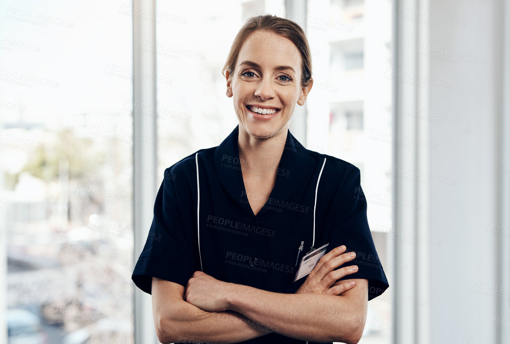 Buy stock photo Cropped shot of a young female caregiver smiling at the camera