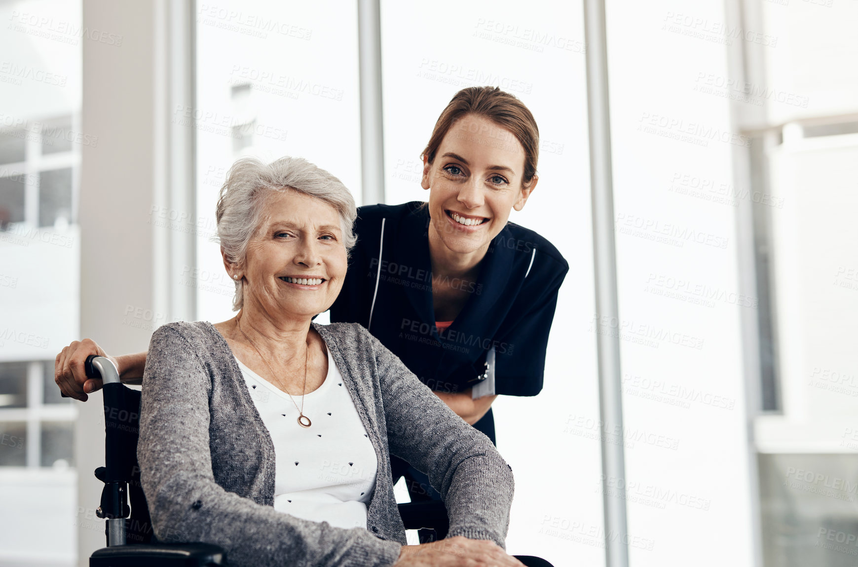 Buy stock photo Cropped shot of a female nurse caring for a senior woman in a wheelchair
