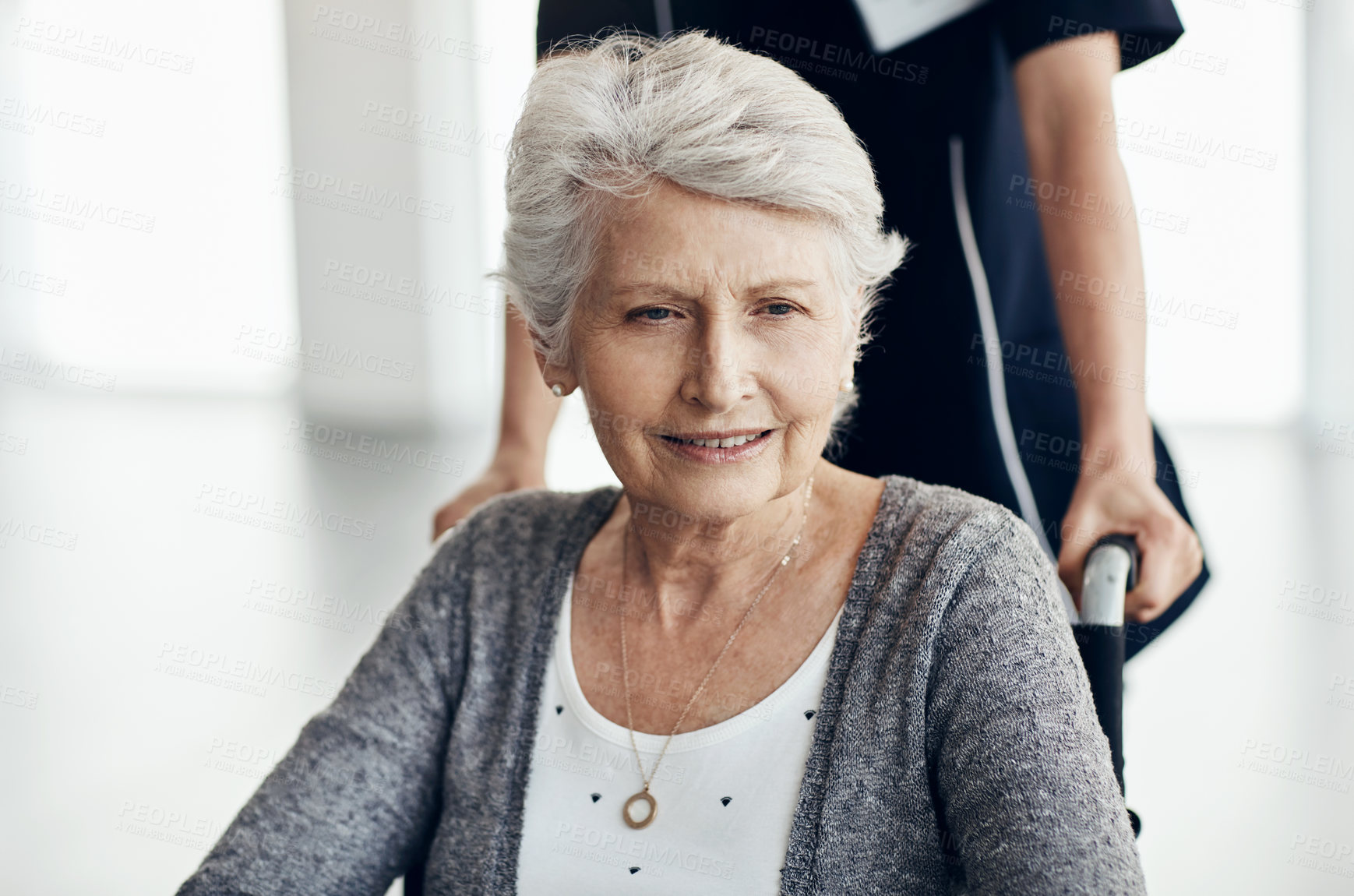 Buy stock photo Cropped shot of a young female caregiver working in a retirement home