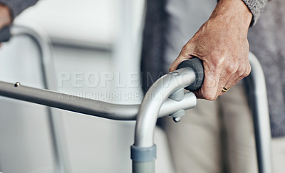 Buy stock photo Shot of an unrecognizable senior woman walking with the assistance of a walker