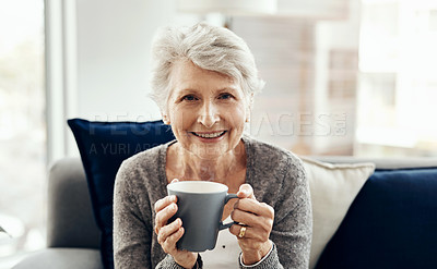 Buy stock photo Shot of a senior woman enjoying a cup of coffee while relaxing at home
