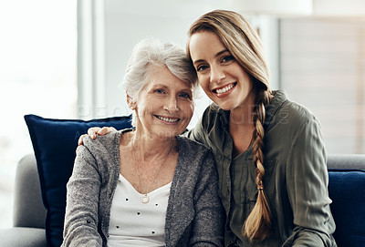 Buy stock photo Cropped shot of a senior woman and her adult daughter sitting together at home