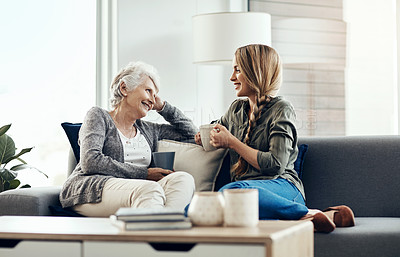 Buy stock photo Cropped shot of a senior woman and her adult daughter sitting together at home