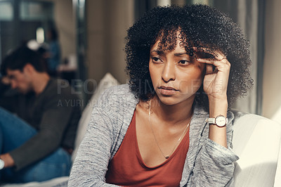 Buy stock photo Shot of a young woman giving her boyfriend the silent treatment after a fight