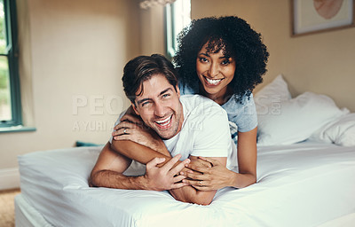 Buy stock photo Shot of an affectionate young couple spending some quality time together in their bedroom at home