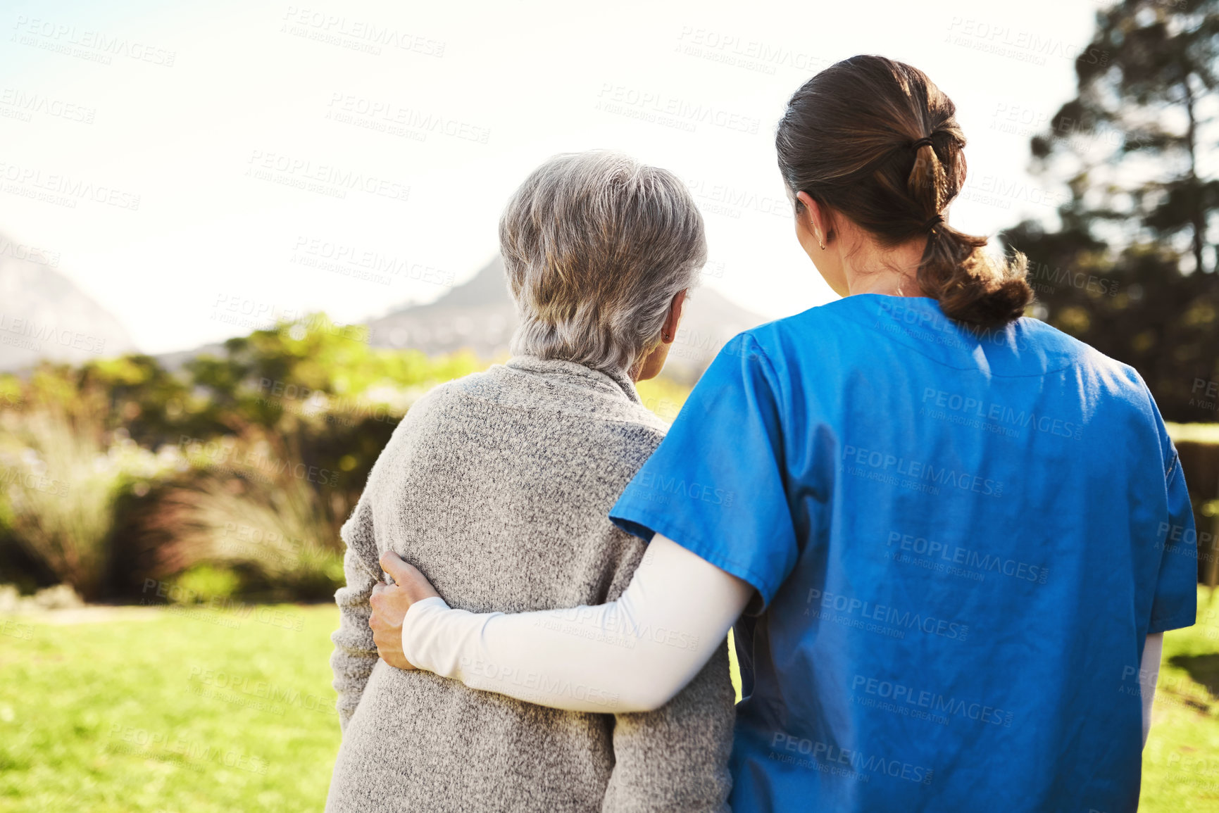 Buy stock photo Senior woman, nurse and hug in healthcare, life insurance or support together in nature. back view of mature female with caregiver in elderly care, medical aid or garden walk at nursing home outdoors