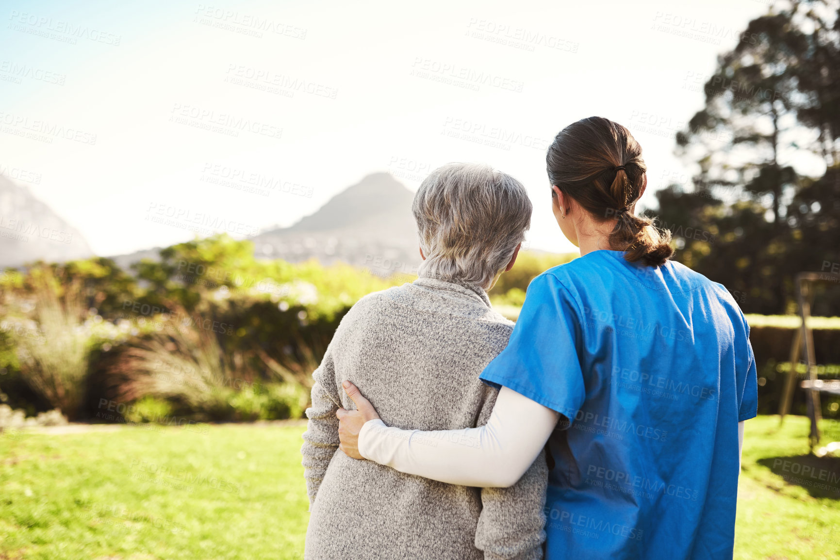 Buy stock photo Cropped shot of a young female nurse outside with a senior patient