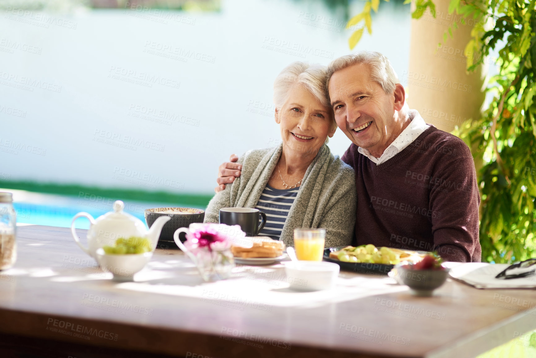 Buy stock photo Portrait of an affectionate senior couple enjoying a meal together outdoors