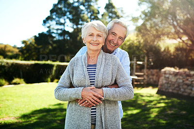 Buy stock photo Portrait of an affectionate senior couple posing together in their back yard at home