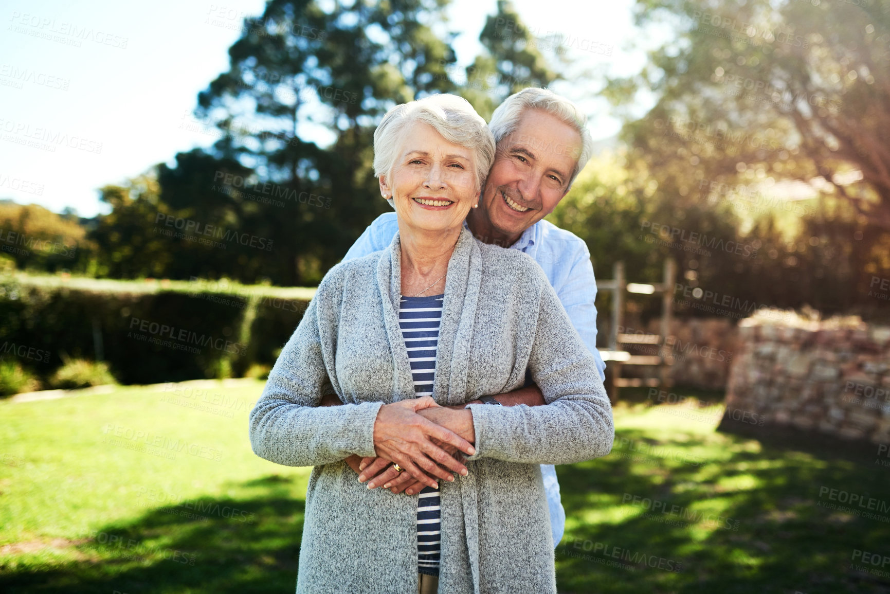 Buy stock photo Portrait of an affectionate senior couple posing together in their back yard at home