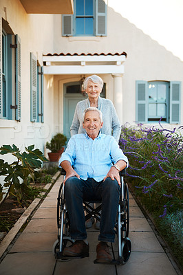 Buy stock photo Full length shot of a cheerful wheelchair bound senior man relaxing with his wife in their backyard at home