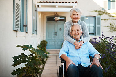 Buy stock photo Portrait of a cheerful wheelchair bound senior man relaxing with his wife in their backyard at home