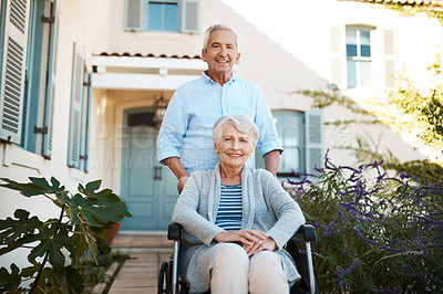 Buy stock photo Portrait of a cheerful wheelchair bound senior woman relaxing with her husband in their backyard at home