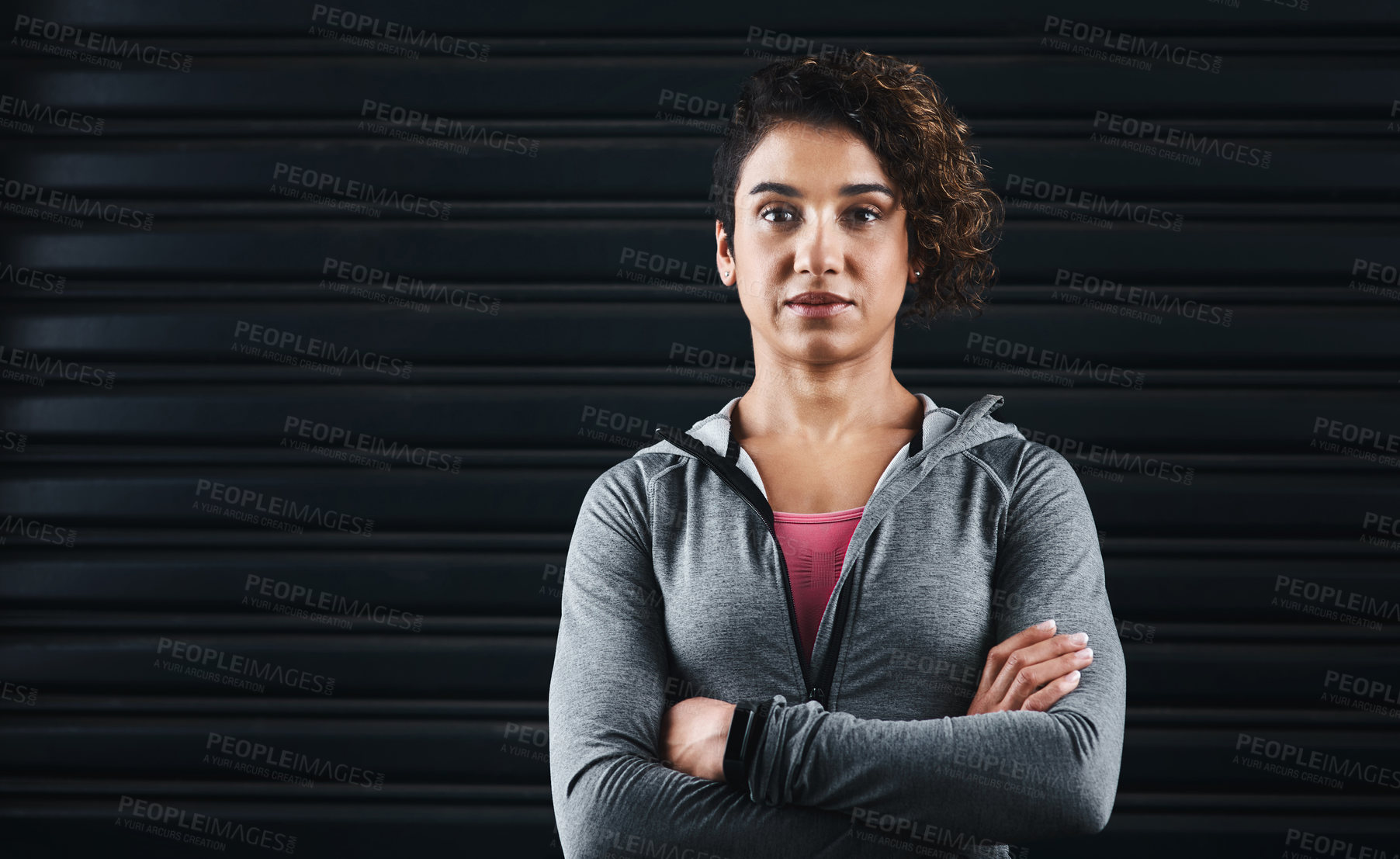 Buy stock photo Cropped portrait of an attractive young woman standing against a black background in her workout clothes before exercising