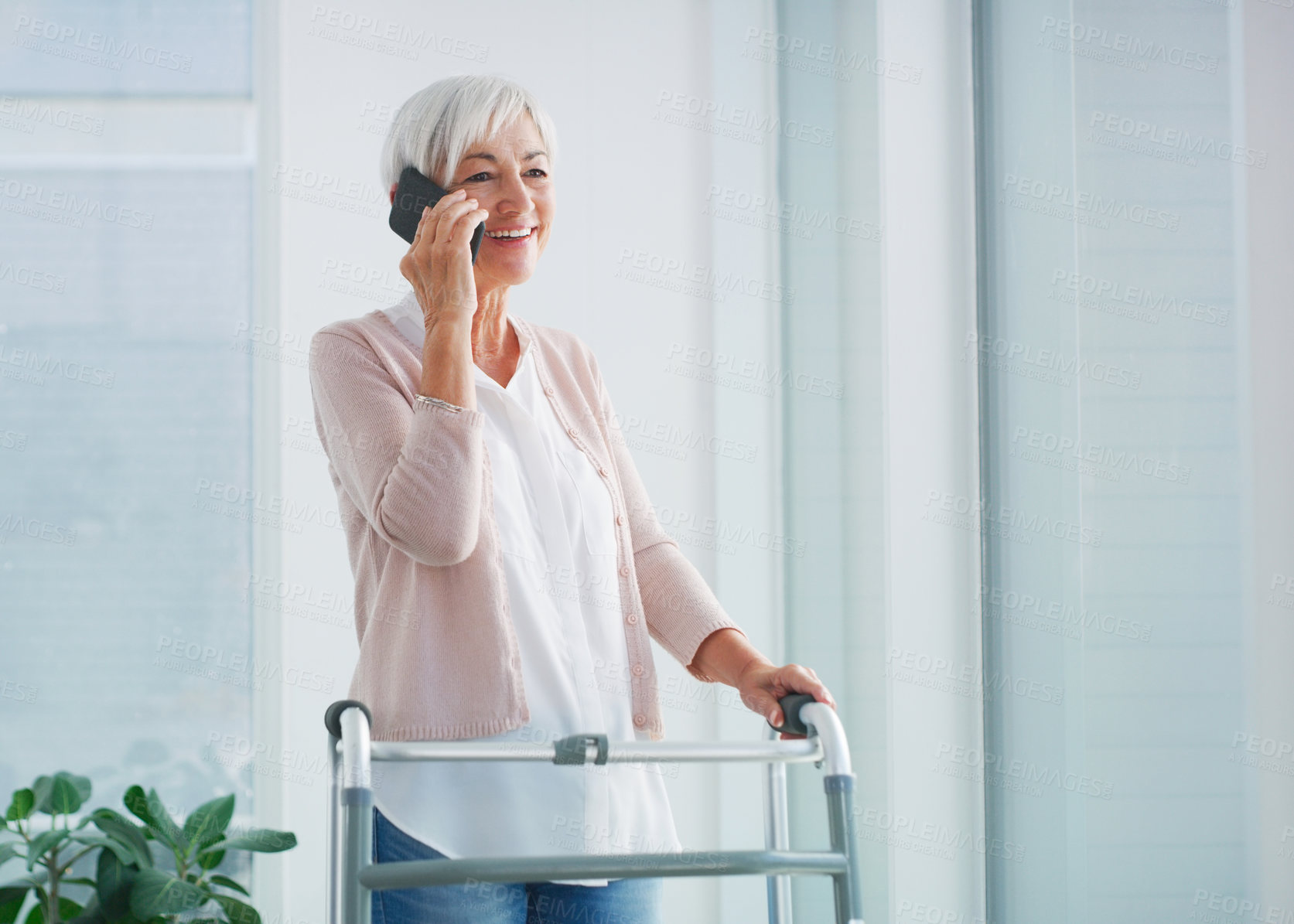 Buy stock photo Phone call, elderly woman and smile in nursing home for talk, communication and support at walker. Connection, female retiree and happy on cell for contact, catch up and long distance chat in lounge