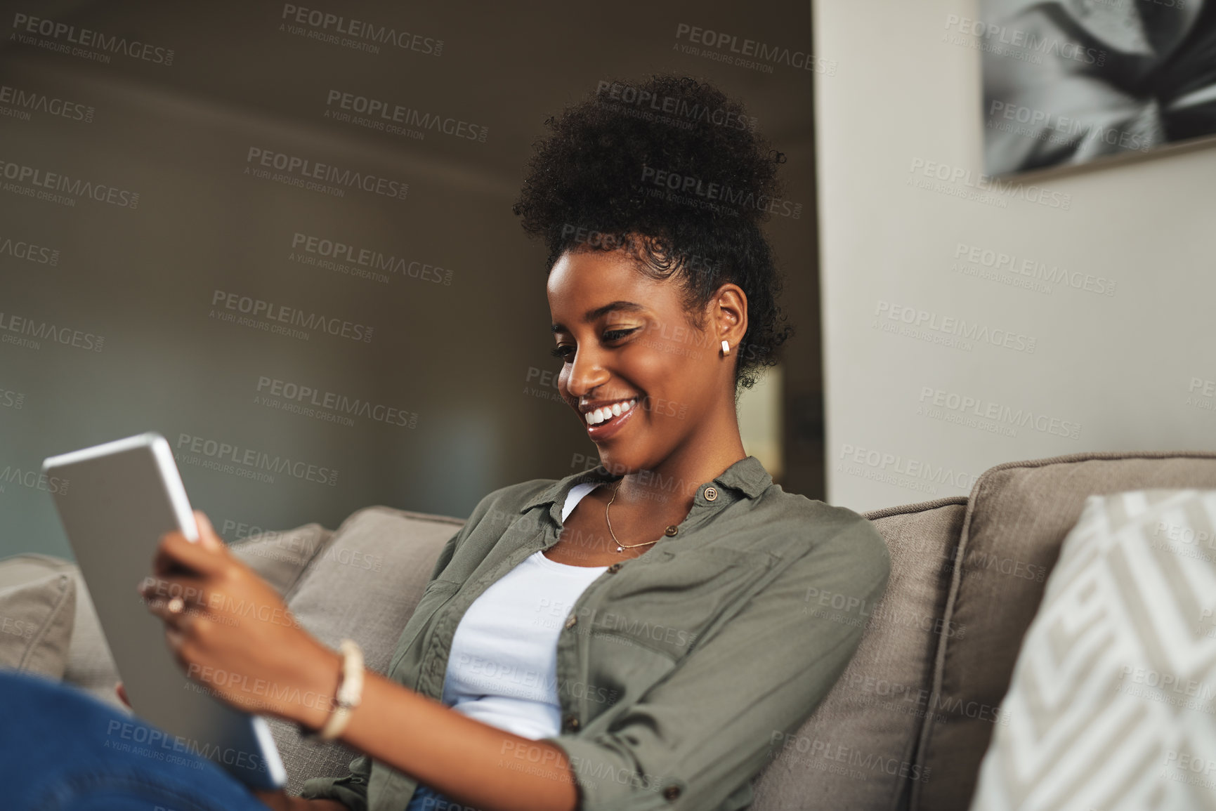 Buy stock photo Relax, home and black woman on sofa on tablet for social media, online shopping and internet. Happy, rest and person on digital tech for reading website, news and research on weekend in living room