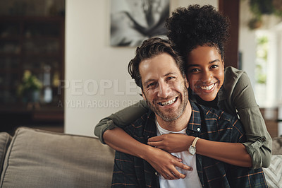 Buy stock photo Portrait of an affectionate young couple spending the day together at home