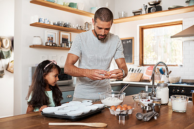 Buy stock photo Cropped shot of a young man baking at home with his young daughter