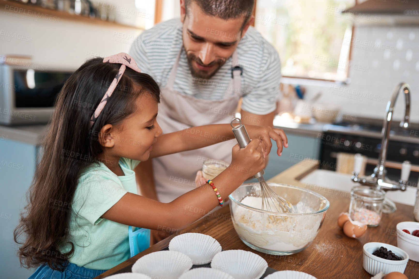 Buy stock photo Cropped shot of a young man baking at home with his young daughter