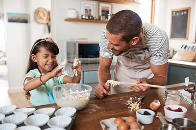 Buy stock photo Cropped shot of a young man baking at home with his young daughter