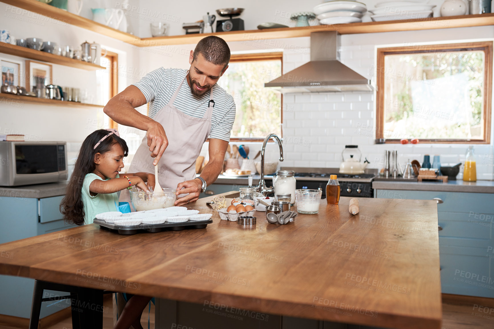 Buy stock photo Cropped shot of a young man baking at home with his young daughter