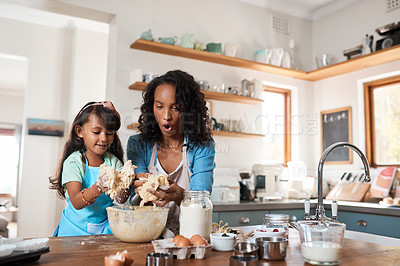 Buy stock photo Shot of a woman baking at home with her young daughter